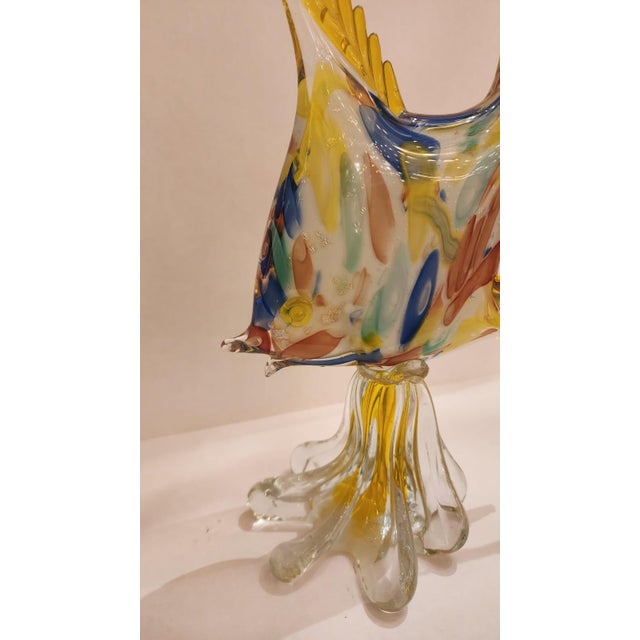 This listing features a beautiful yellow Murano style glass fish sculpture. Shown are yellow fins with a colorful body...