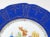 A striking vintage Czechoslovakian porcelain plate featuring a vibrant cobalt blue border adorned with intricate gilt...