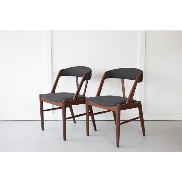 A pair of rare Danish carver chairs, attributed to Hans Hovmand Olsen. The chairs have solid teak frames and have been...