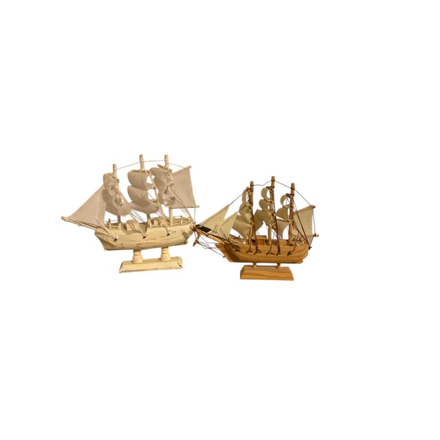 Offering this pair of miniature pirate ship models. Each is made from wood with cloth sails. The white leans a bit just as...