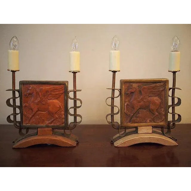 A pair of terracotta bas relief tiles depicting the mythological horse, Pegasus, and presented as lamps; the tiles mounted...