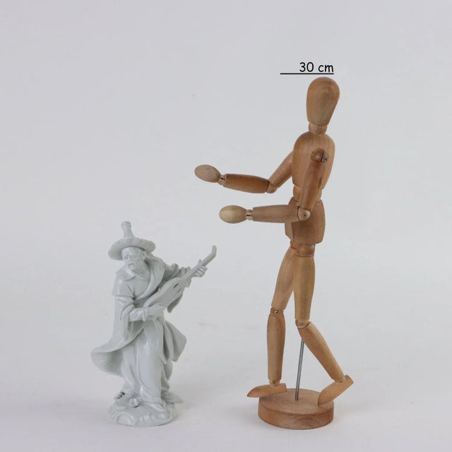 White porcelain sculpture depicting the figure of an oriental man. Under the base the manufacturer's brand. This piece is...