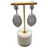 Intricate and captivating, these exquisite drop earrings feature a textured design with a shimmering white gold finish....