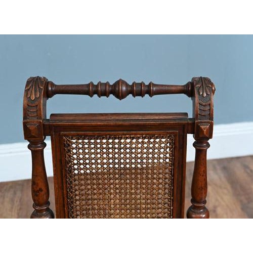 These are a pair of antique Victorian side chairs featuring carved wooden frames and hand-caned seats and backs Great...