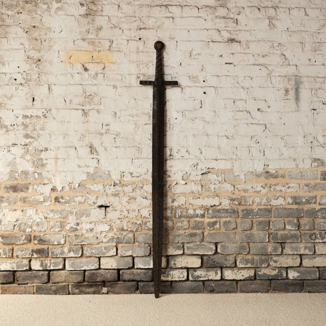 Add a striking piece of European history to your collection with this 20th century French iron sword, a decorative object...