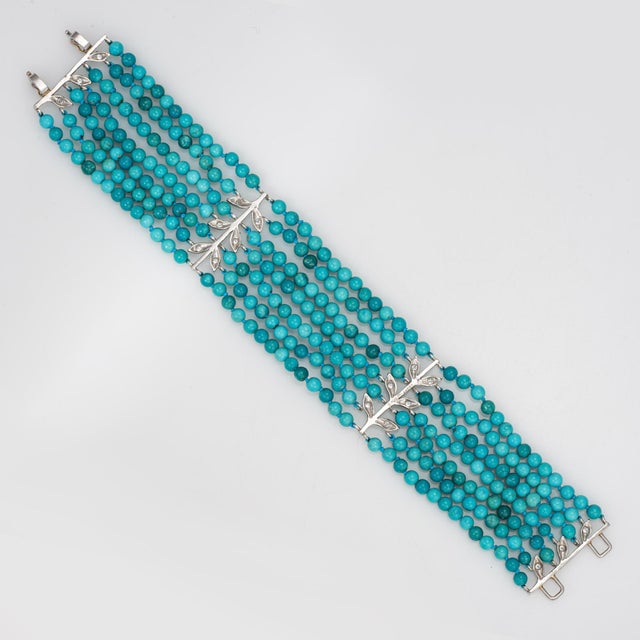 Finely detailed pre-owned Cathy Waterman 7 strand turquoise & diamond bracelet crafted in 900 platinum. Seven strands of...
