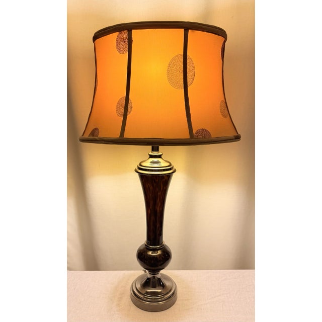 Illuminate your space with this stunning late twentieth century contemporary faux tortoise shell table lamp, a perfect...