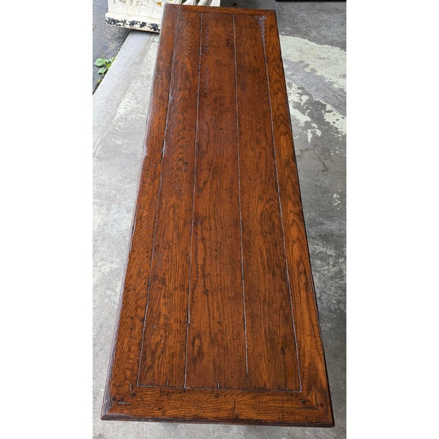 Substantial console table from the Melrose Collection, designed in an English country or European farmhouse style. It...
