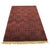 This hand knotted pile rug features a primary red and rust color palette suitable for a variety of interior settings....