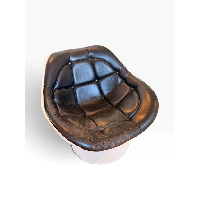 A sculptural space-age lounge chair from the 1970s, attributed to Italy. It features a solid, cream-white fiberglass...