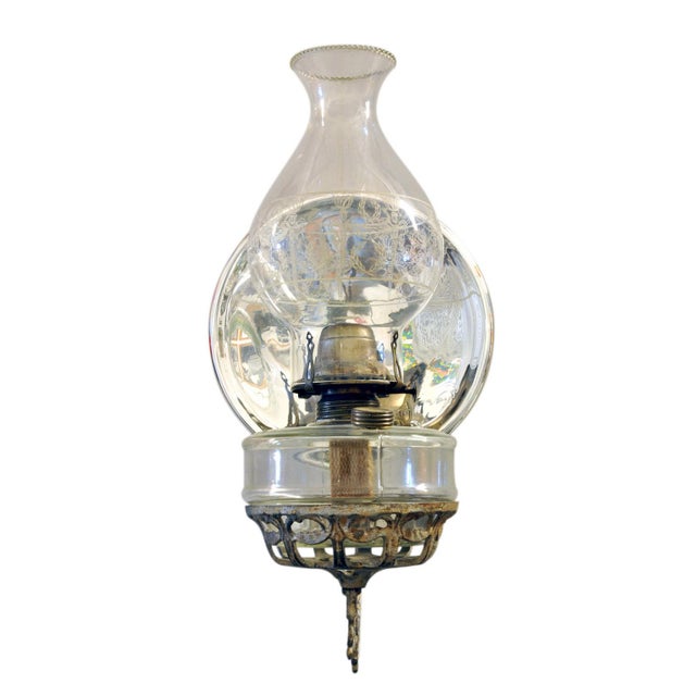 An Antique Cast Iron Wall Bracket Oil Lamp with reflector. Swivels from side to side. A wonderful aged decorative piece...