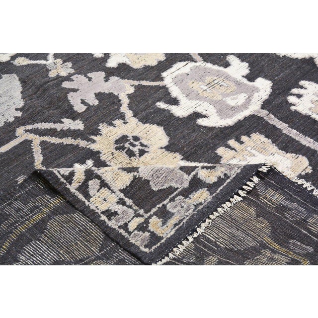 Oushak hand knotted wool rug with soft texture.