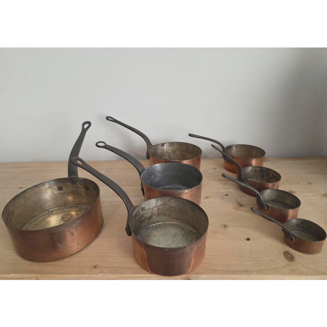 The loop-end iron handles are the tell. This is not decorative copper — these are professional French kitchen pots built...
