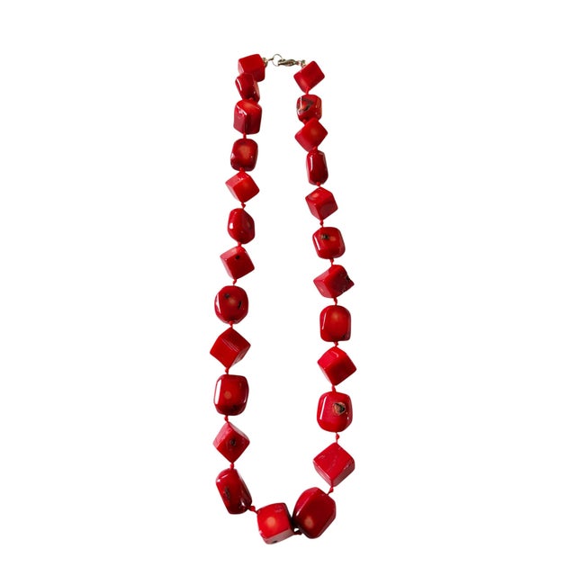 This exquisite choker necklace features 25 Nepalese natural red coral beads, each measuring 0.50" wide by 0.25" deep,...