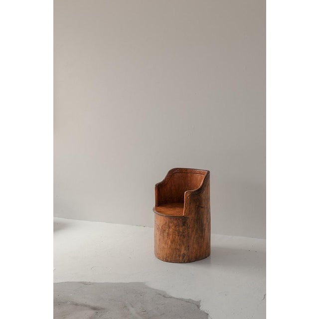 Rustic armchair produced in Sweden, 1962. This patinated chair is made from a single large piece of pine wood and it is...