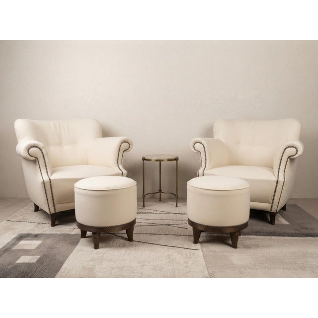 A magnificent and harmonious matched set of four pieces featuring two fully refurbished vintage retro armchairs...