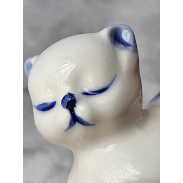 Two ceramic cats, glazed in floral blue and white. Mom and kitten are resting sweetly. Beautiful simple style that makes a...