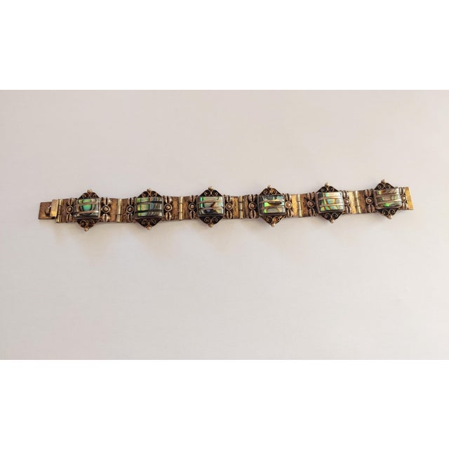 Here's a lovely 6 link bracelet signed Iguala 925 LMH Hecho en Mexico. It features sterling silver panels with abalone...