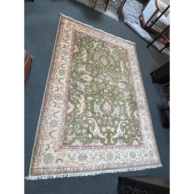 Design Plus Gallery presents a 6ft 2in × 9ft Hand-Knotted Wool Oriental Style Area Rug. This wool rug showcases an olive...