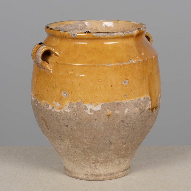 A 19th century French earthenware pot à confit with traditional yellow glaze. Good condition with minor chips and losses...