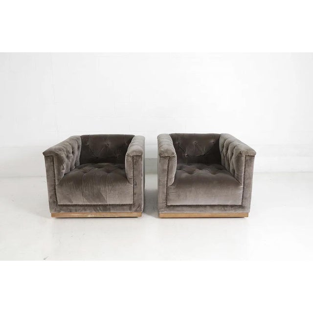 Fabulous pair of SOHO / Hollywood chic tufted velvet swivel armchairs by Four Hands (label attached). The chairs are...