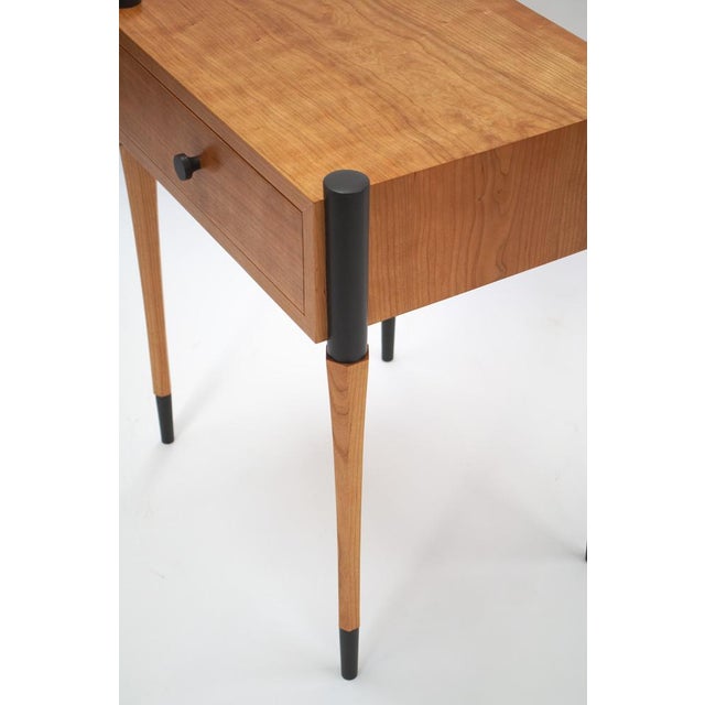 Beautiful cherry side table in cherry with ebonized accents crafted by Peter Aleksa. The hexagonal curved tapered legs...