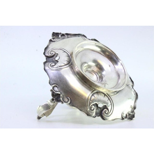 Silver paddle with shell-shaped reliefs and cut-outs with an acanthus leaf application on the handle This piece has an...