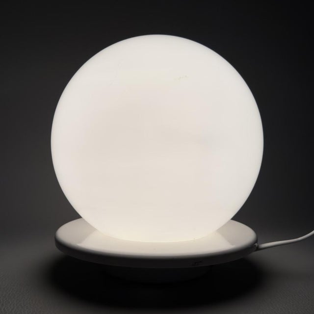 An iconic lighting accessory with a futuristic design, typical of the Italian space age of the 1960s and 1970s. This table...