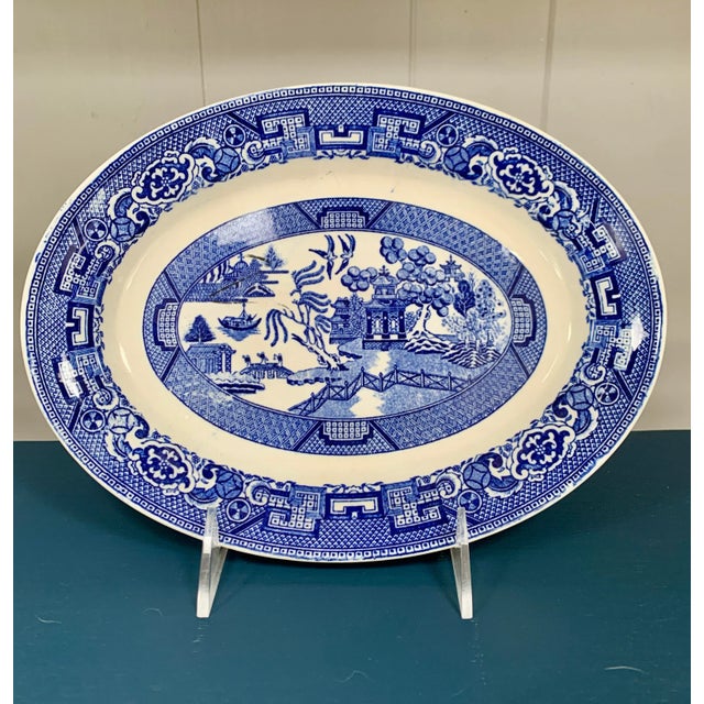 An original 1940s blue willow oval platter with a diameter of 11” by Homer Laughlin China Company. This vintage piece of...