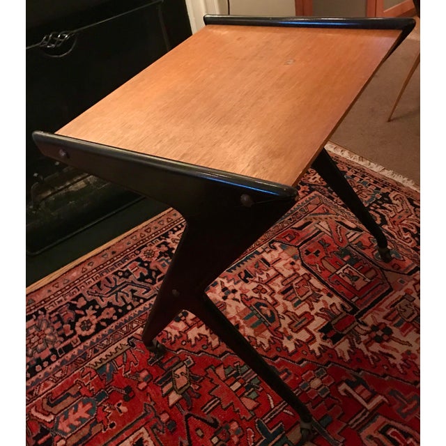 This Mid 20th Century French student desk is made of oak panels suspended within a dramatic black-painted Z-shaped frame...