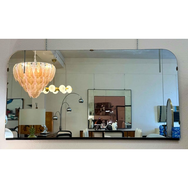 Elegant Italian mirror from the 1940s, featuring a refined rectangular shape with rounded upper corners and a...