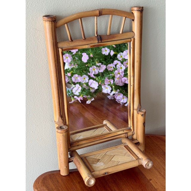Small charming bamboo mirror with original glass plate and lovely, timeworn appeal. Perfect anywhere you'd like to add...