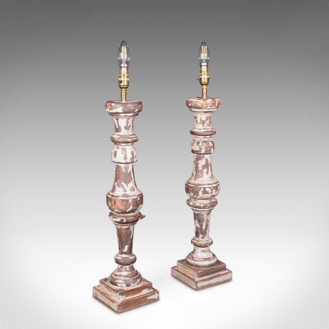 This is a pair of antique lamp bases. An English, turned and painted pine electric light, dating to the late Victorian...