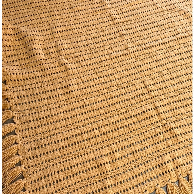 Beautiful vintage handmade crocheted afghan blanket dating to the 1960s, featuring a classic repeating open-weave design...