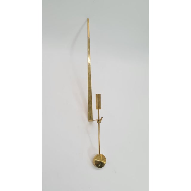 Scandinavian wall candle holder “lampett pendel”, made of solid brass, designed by pierre forssell for the renowned...
