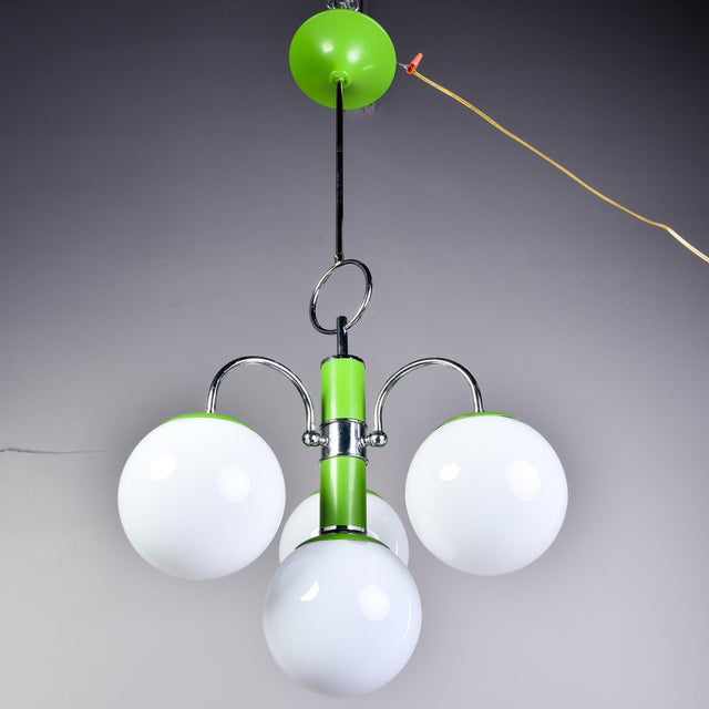 Found in Italy, this four light fixture dates from the early 1970s. Polished chrome frame with apple green enamel accents...