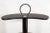 This circular bar cart by Design Institute of America (DIA) comes in black lacquered wood with three tiers of revolving...