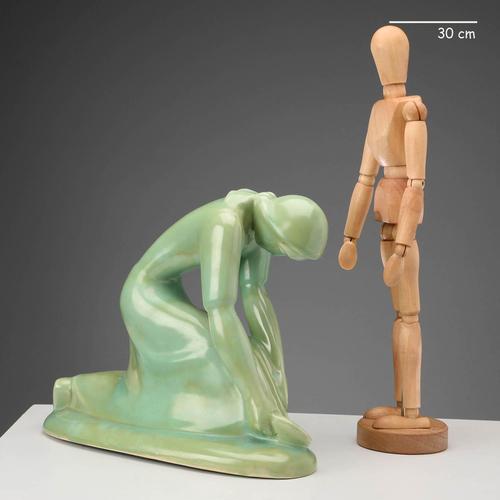 Cast ceramic sculpture in shades of green depicting 'The Reaper'. The work does not have the manufacturer's mark. This...