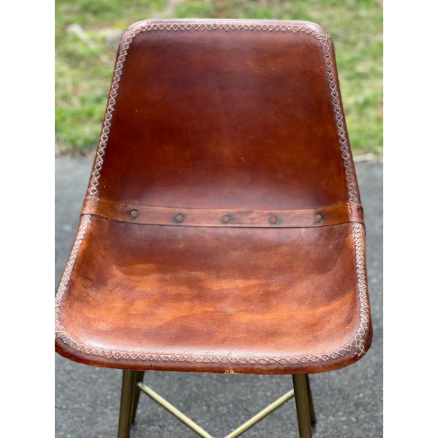 1960s leather wrapped fiberglass side bucket/shell chairs. Chairs have chunky white stitching and rustic leather band...