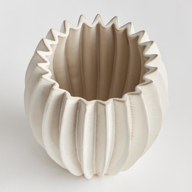With a rounded form, deep ribbing and thickly applied glaze, this natureinspired pot is a work of art. The handfinished...