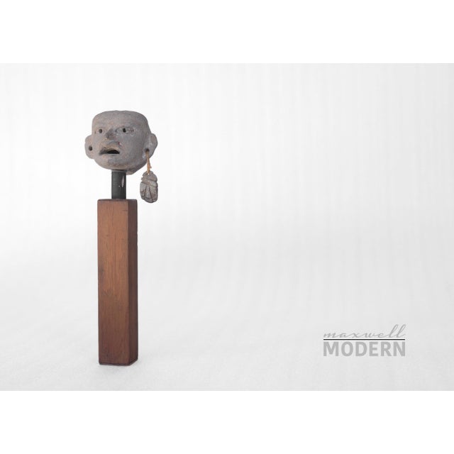 Beautiful small pottery head on teak stand. It was acquired with one earring so I'm not certain if it originally came with...