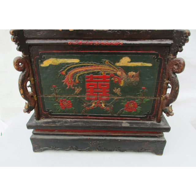 Provincial wooden trunk with serving tray. The edges are carved with dragons, each side is a carved cartouche featuring...
