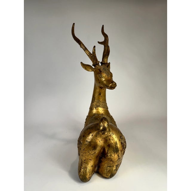 Gilt metal Moroccan deer statue. Whether it year round, this element creates a grand statement in any space.