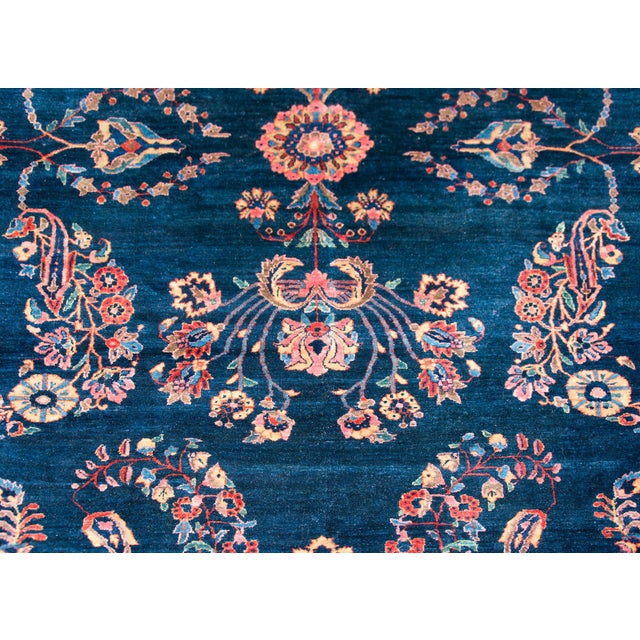 A wonderful early 20th century Persian Sarouk Mohajeran rug with a large-scale mirror floral pattern woven in traditional...