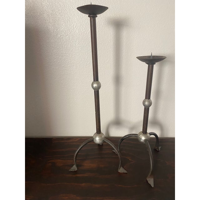 Pair of Brutalist floor candle holders Metal and tin, lot of patina The metal shows tears due to the crafting process...