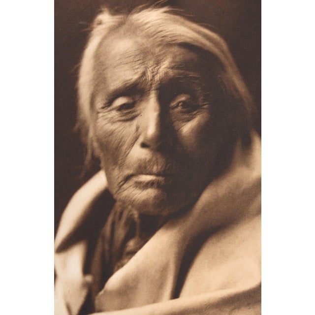 An original photogravure from Edward S. Curtis's The North American Indian. Skúthŭn - Klickitat is a close portrait of a...