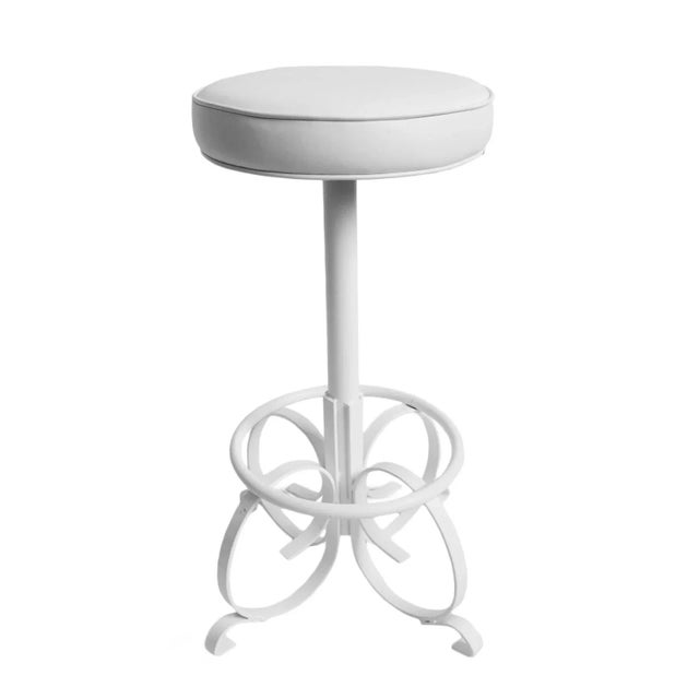 Vintage bar stool with powder coated white twisting iron base with faux leather white vinyl seat. Charming and unique...