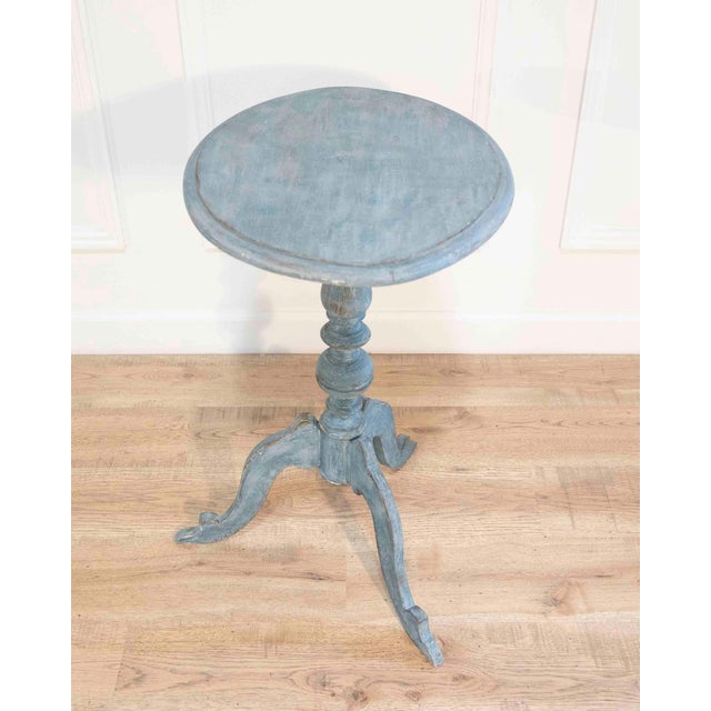 Elegant 19th-century Swedish tripod table featuring a refined oval top supported by a turned central column and three...