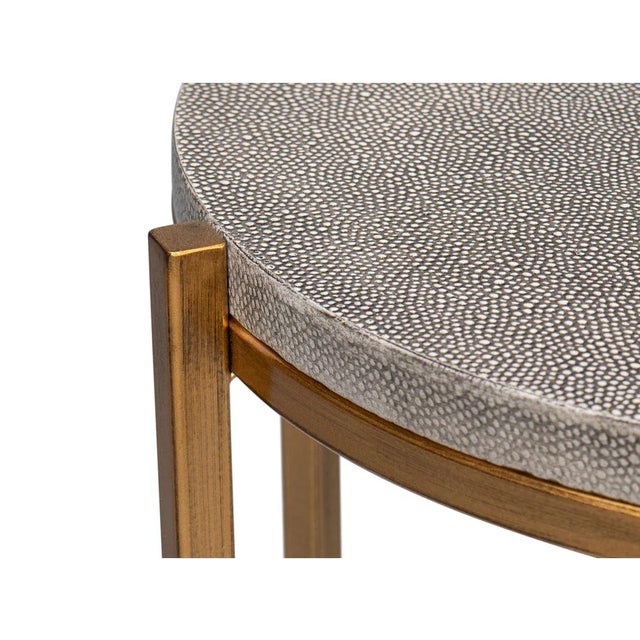 Leather Top Accent Table with leather-wrapped round top supported by a six-legged gilt metal base with a stretcher....