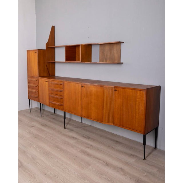 Wall-mounted sideboard, the structure includes a lower sideboard with drawers and doors, an additional tall cabinet on the...